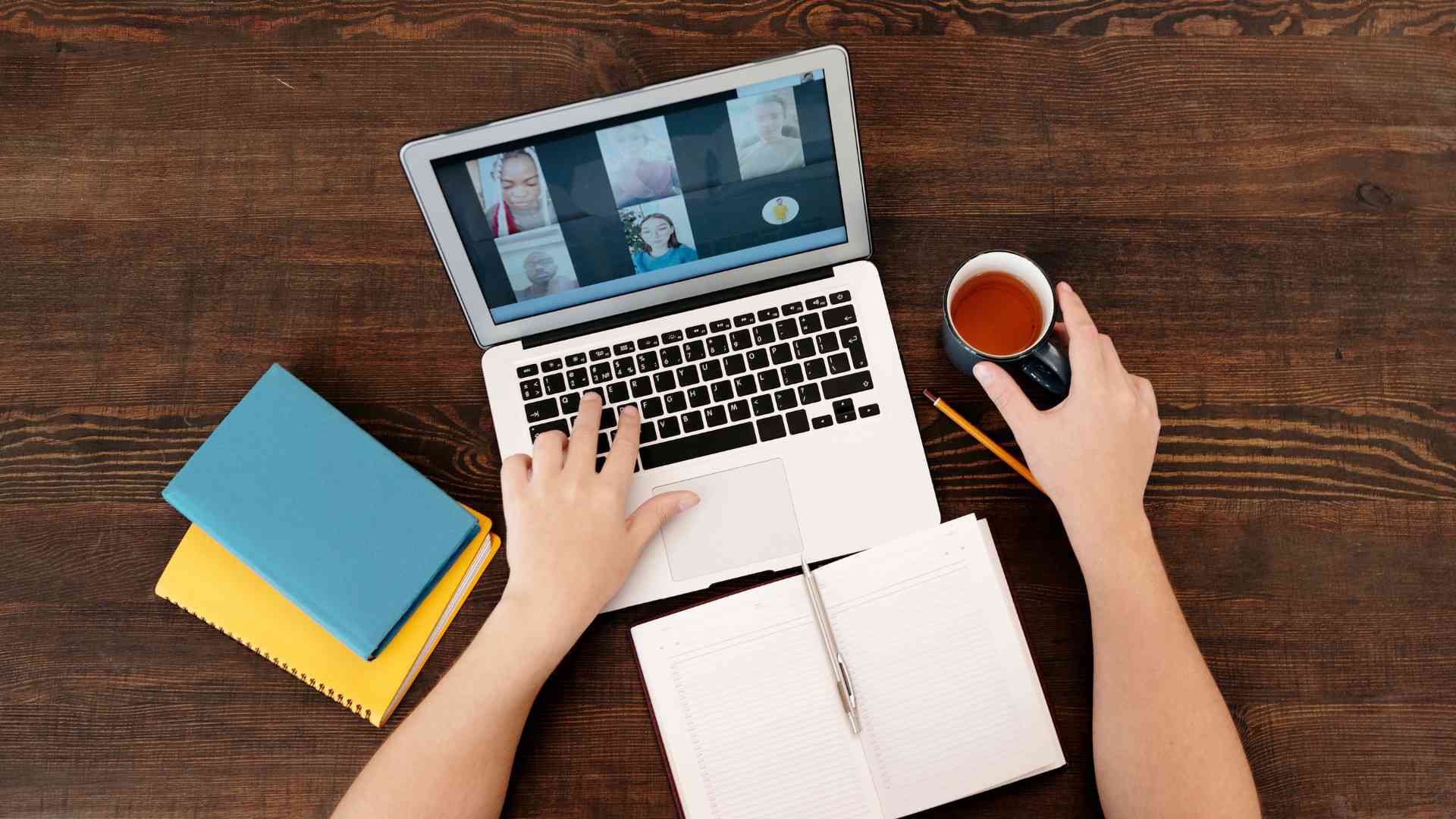 Business owner having a zoom meeting with the virtual assistant and other team members while documenting the processes for the reference of the VA.