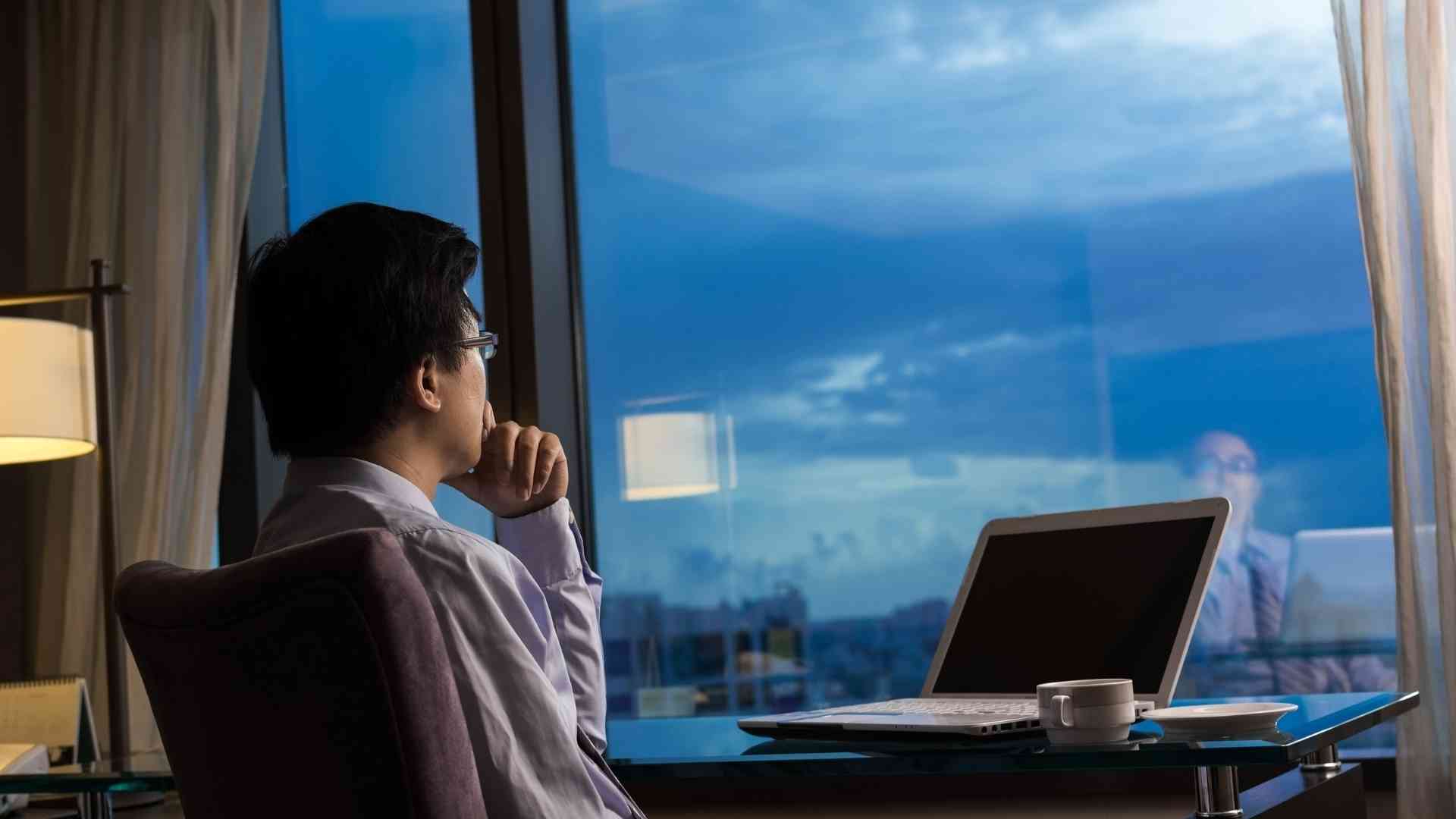 business owner in deep thought on either employing a virtual assistant or a regular employee