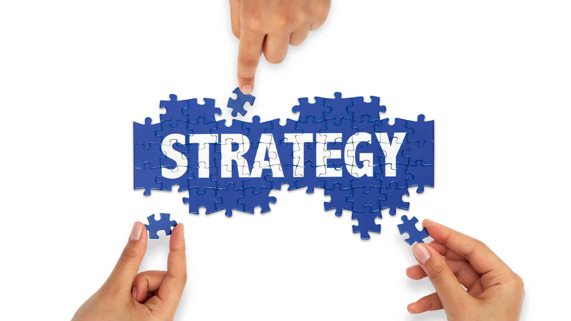 Hands assembling puzzle pieces to form the word "strategy," symbolizing collaboration to make asynchronous work effective.