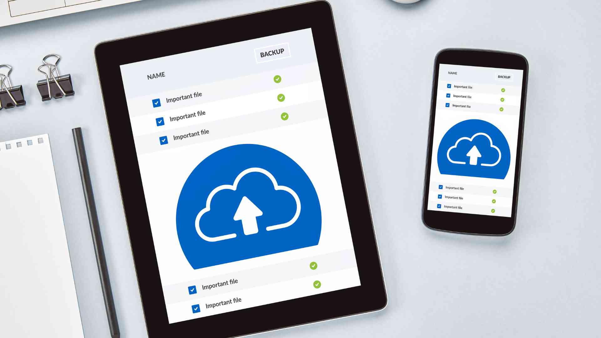 Tablet and smartphone showing cloud backup icons, symbolizing data management solutions.